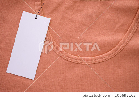 Blank white clothes tag label on new shirt Blank white clothes tag label on new shirt 100692162