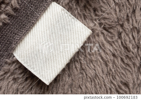 Blank white laundry care clothing label on fur texture background Blank white laundry care clothing label on fur texture background 100692183