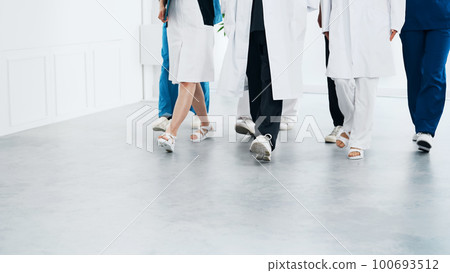 A group of medical workers walking in a hospital doctor nurse A group of medical workers walking in a hospital doctor nurse 100693512