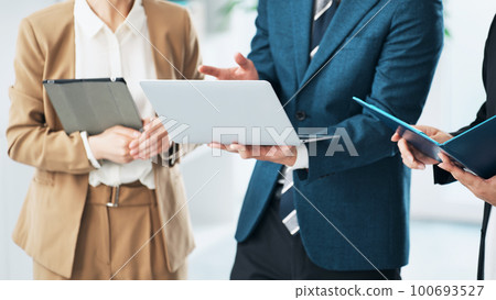 Group of business people having a conversation in the office 100693527