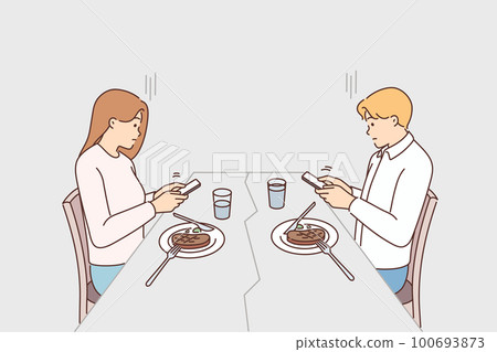 Couple distracted from dinner using smartphones  100693873