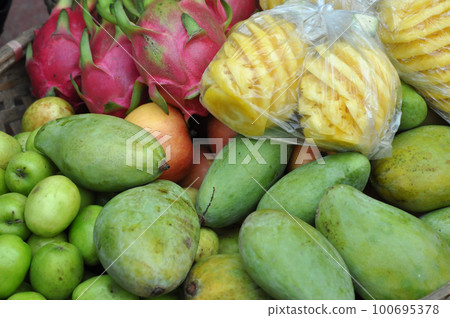 Basket full with exotic fruits in a market. Vietnam 100695378