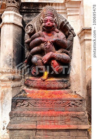 Old deity of Narasimha, the avatar of the Hindu god Vishnu, in a public square in Bhaktapur, Nepal 100695478