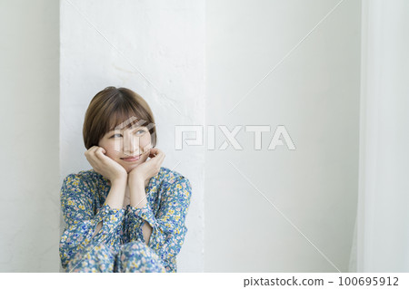 Portrait of a young woman with short hair 100695912