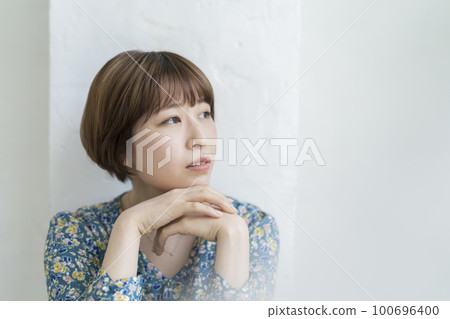 Young woman with short hair worried thinking image Young woman with short hair worried thinking image 100696400