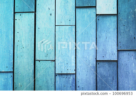 Background made of old, light blue boards. The weathered texture and faded color of the boards give a sense of age and history. The simplicity of the image creates a calm and peaceful atmosphere Background made of old, light blue boards. The weathered texture and faded color of the boards give a sense of age and history. The simplicity of the image creates a calm and peaceful atmosphere 100696953
