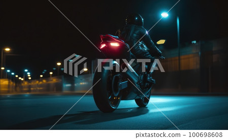 A man rides a sports motorcycle in the city at night A man rides a sports motorcycle in the city at night 100698608