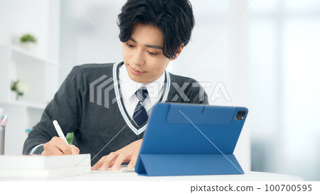 Male student studying with a tablet Male student studying with a tablet 100700595