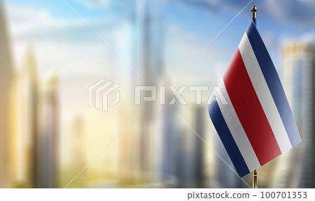 Small flags of the Costa Rica on an abstract blurry background 100701353