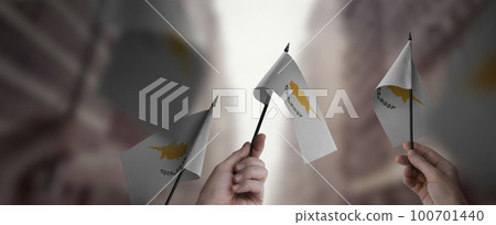 A group of people holding small flags of the Cyprus in their hands 100701440