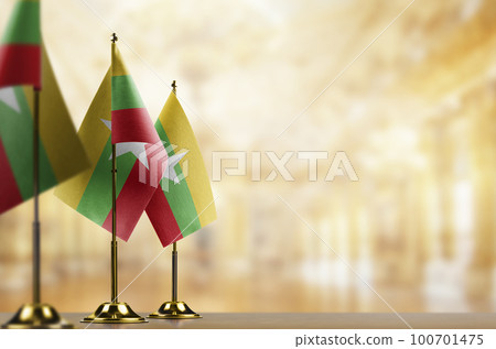 Small flags of the Myanmar on an abstract blurry background Small flags of the Myanmar on an abstract blurry background 100701475