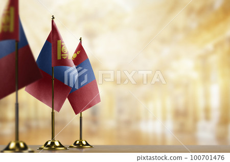 Small flags of the Mongolia on an abstract blurry background 100701476