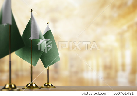 Small flags of the Pakistan on an abstract blurry background 100701481