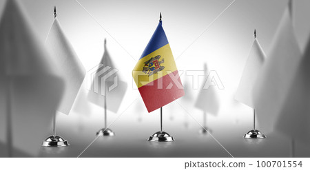 The national flag of the Moldavia surrounded by white flags 100701554