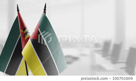 Small flags of the Mozambique on an abstract blurry background 100701609