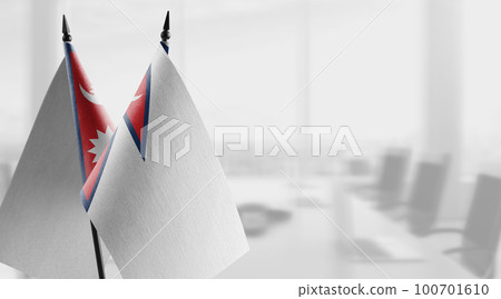 Small flags of the Nepal on an abstract blurry background Small flags of the Nepal on an abstract blurry background 100701610