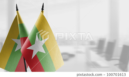 Small flags of the Myanmar on an abstract blurry background Small flags of the Myanmar on an abstract blurry background 100701613