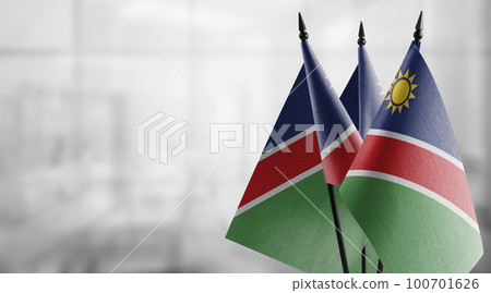 Small flags of the Namibia on an abstract blurry background 100701626