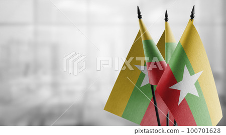 Small flags of the Myanmar on an abstract blurry background Small flags of the Myanmar on an abstract blurry background 100701628