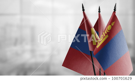 Small flags of the Mongolia on an abstract blurry background 100701629
