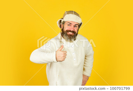 mature man posing with funny outfit. man beard in winter hat. portrait of trendy guy wearing hat. Male winter style. Modern winter earflap beanie hat. Funky happy bearded man. Before celebration mature man posing with funny outfit. man beard in winter hat. portrait of trendy guy wearing hat. Male winter style. Modern winter earflap beanie hat. Funky happy bearded man. Before celebration 100701799