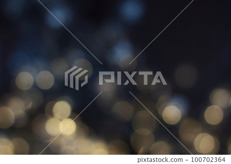 Blurred magic fairy lights with an abstract bokeh effect against a dark background Blurred magic fairy lights with an abstract bokeh effect against a dark background 100702364