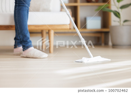 Woman cleaning the floor 100702462