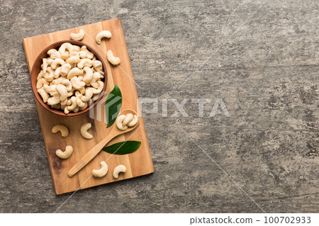 cashew nuts in wooden bowl on table background. top view. Space for text Healthy food 100702933
