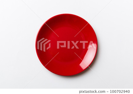 Top view of isolated of colored background empty round red plate for food. Empty dish with space for your design Top view of isolated of colored background empty round red plate for food. Empty dish with space for your design 100702940