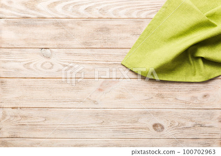 top view with green kitchen napkin isolated on table background. Folded cloth for mockup with copy space, Flat lay. Minimal style top view with green kitchen napkin isolated on table background. Folded cloth for mockup with copy space, Flat lay. Minimal style 100702963