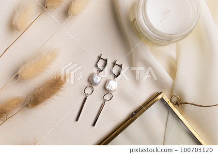 Elegant jewelry set of silver pearl earrings with gem. Jewelry set minimalist style. Handmade bijouterie concept. Elegant jewelry set of silver pearl earrings with gem. Jewelry set minimalist style. Handmade bijouterie concept. 100703120