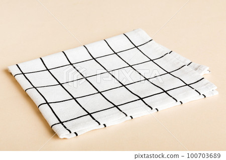 top view with white empty kitchen napkin isolated on table background. Folded cloth for mockup with copy space, Flat lay. Minimal style top view with white empty kitchen napkin isolated on table background. Folded cloth for mockup with copy space, Flat lay. Minimal style 100703689