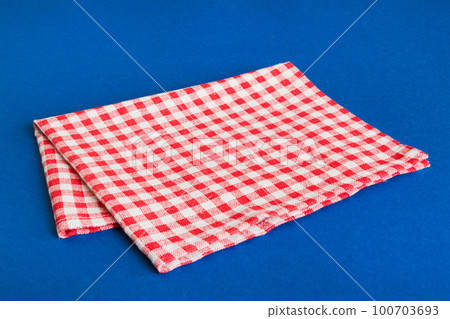 top view with red empty kitchen napkin isolated on table background. Folded cloth for mockup with copy space, Flat lay. Minimal style top view with red empty kitchen napkin isolated on table background. Folded cloth for mockup with copy space, Flat lay. Minimal style 100703693