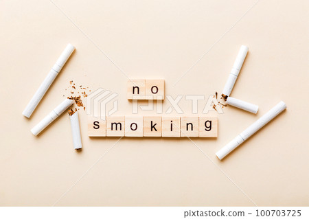 Cigarette And Wooden Blocks, Broken cigarette on table background, No Tobacco Day with hourglass, clock health concept. time to quit smoking 100703725