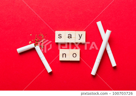 Cigarette And Wooden Blocks, Broken cigarette on table background, No Tobacco Day with hourglass, clock health concept. time to quit smoking Cigarette And Wooden Blocks, Broken cigarette on table background, No Tobacco Day with hourglass, clock health concept. time to quit smoking 100703726