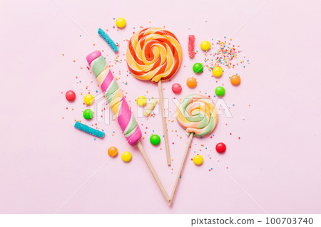 Tasty appetizing Party Accessories Happy Birthday Sweet. Different types of candies on colored background, copy space. Colorful birthday party background Tasty appetizing Party Accessories Happy Birthday Sweet. Different types of candies on colored background, copy space. Colorful birthday party background 100703740