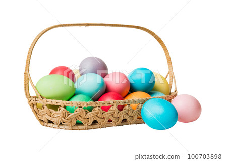 Basket of colorful Easter eggs isolated on white background. Easter basket filled with colored eggs top view holiday concept Basket of colorful Easter eggs isolated on white background. Easter basket filled with colored eggs top view holiday concept 100703898