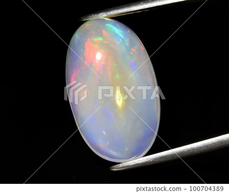 Natural gemstone opal on black background Natural gemstone opal on black background 100704389