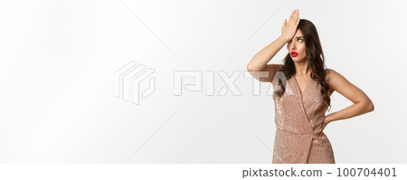 Annoyed stylish woman in glamour dress making facepalm, roll eyes irritated with something stupid, standing on party over white background Annoyed stylish woman in glamour dress making facepalm, roll eyes irritated with something stupid, standing on party over white background 100704401