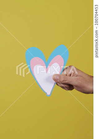 person holding a blue, pink and white heart 100704453