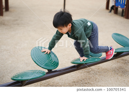 A boy playing in a park A boy playing in a park 100705341
