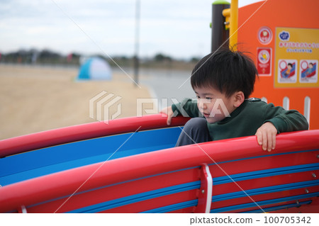 A boy playing in a park A boy playing in a park 100705342