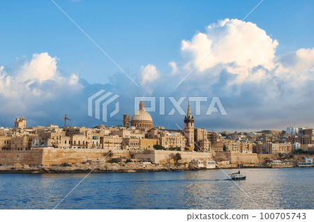 Valletta city skyline with a blue sky with big fluffy dramatic clouds in the background Valletta city skyline with a blue sky with big fluffy dramatic clouds in the background 100705743