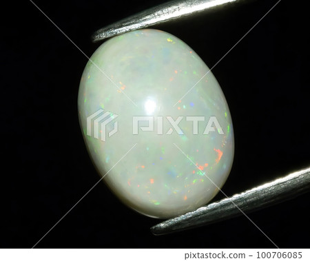 Natural gemstone opal on black background 100706085