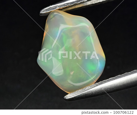 Natural gemstone opal on black background 100706122