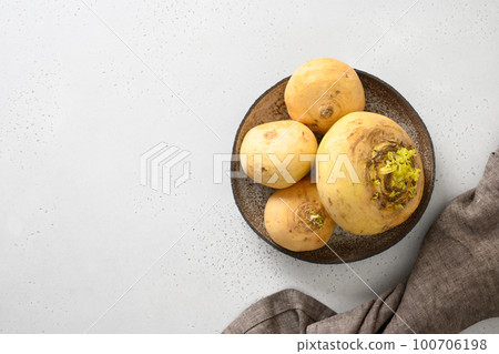 Fresh turnip with stems in plate. Autumn harvest. Fresh turnip with stems in plate. Autumn harvest. 100706198