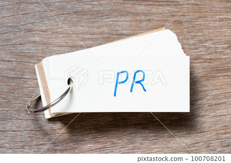 Flash card with handwriting in word PR (Abbreviation of purchase requisition or public relations) on wood background 100708201