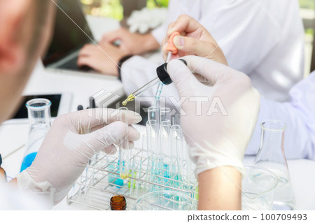 Team of researcher or scientists working in laboratory. Team of researcher or scientists working in laboratory. 100709493