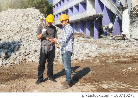 Demolition control supervisor and contractor discussing on demolish building. Demolition control supervisor and contractor discussing on demolish building. 100710275