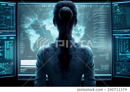 view from back to female student sitting at desk in front of monitor. 100711374